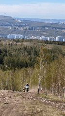 Motorcyclists ride rocky hillside trail near Krasnoyarsk, Russia
