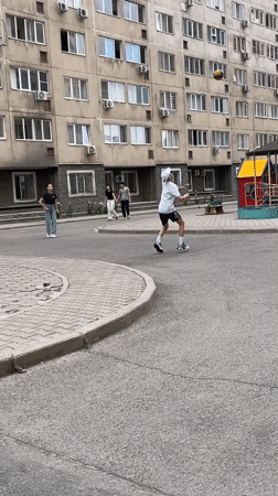 Everyday life around Almaty apartment blocks on a cloudy June morning