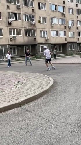 Everyday life around Almaty apartment blocks on a cloudy June morning