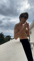 Man enjoys banana and wine on Montenegro balcony
