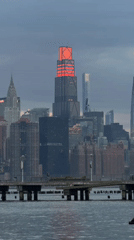 NYC skyline captured at dusk from waterfront pier