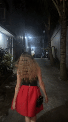 Woman walks through narrow alleyway in North Kuta, Indonesia