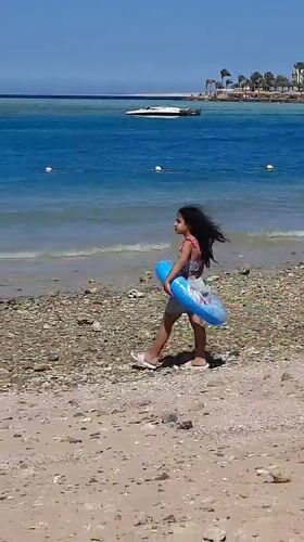 Family enjoys sunny beach day in Hurghada, Egypt