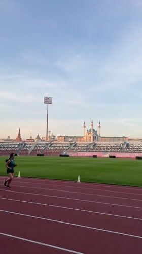 Runner trains at Kazan stadium near historic Kremlin complex