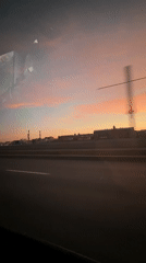 Sunset viewed from moving vehicle on Saint Petersburg highway