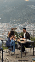 Couple dines with scenic views at Alanya restaurant terrace