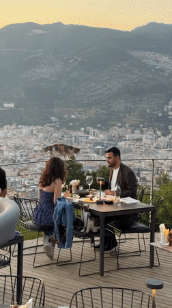 Couple dines with scenic views at Alanya restaurant terrace
