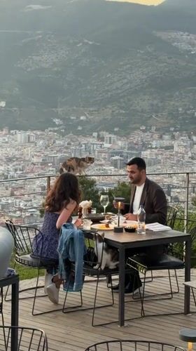 Couple dines with scenic views at Alanya restaurant terrace