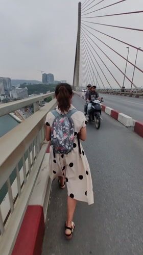 Pedestrians Walk, Photograph on Bai Chay Bridge Vietnam