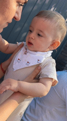 Family gathering with crying baby captured in Goryachevodsky