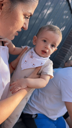 Family gathering with crying baby captured in Goryachevodsky