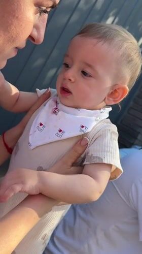 Family gathering with crying baby captured in Goryachevodsky