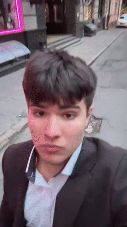 Man films himself near blooming tree in Kyiv