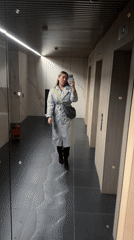 Woman takes selfie in modern elevator lobby in Khimki