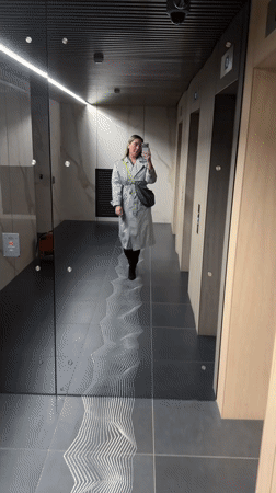 Woman takes selfie in modern elevator lobby in Khimki