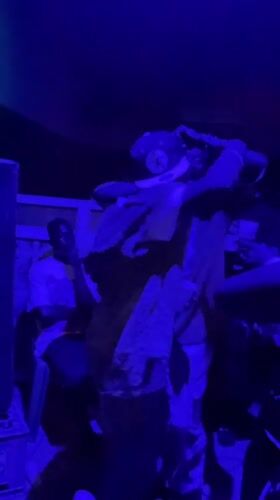 Young people dance at blue-lit party in Nigeria