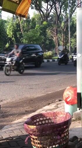 Everyday street traffic flows through Candi, East Java