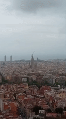 Cloudy day captures panoramic views across Barcelona featuring Sagrada Familia