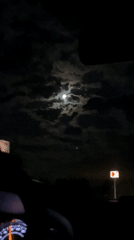 Full moon spotted through clouds in Niva, Russia