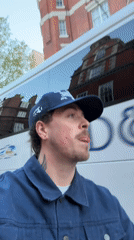 Man films selfie video on London street near bus