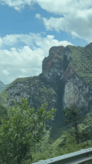 Traveler documents rural Vietnamese mountain landscapes from moving vehicle