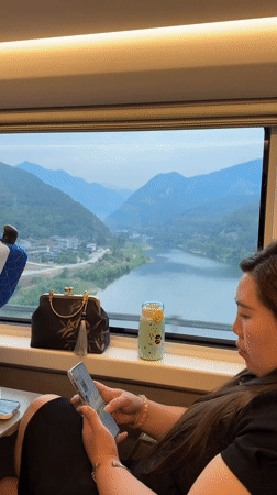 Train passengers use phones during journey through Jiange County