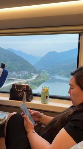 Train passengers use phones during journey through Jiange County