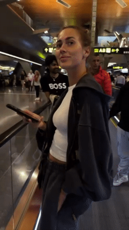 Evening travelers navigate Doha airport with luxury displays