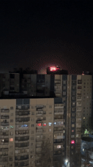 Nighttime fireworks display over Saint Petersburg apartment building