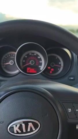 This video captures a drive through Azatavan, Armenia, as indicated by the on-screen text. The camera, positioned inside a Kia, shows the dashboard with a speedometer and other indicators, suggesting the car is in motion. The time of day appears to be late afternoon or early evening, with the sky exhibiting a soft, warm light and scattered clouds.

The main visual focus shifts to the expansive landscape outside the car windows. In the distance, the majestic twin peaks of Mount Ararat are clearly visible, their snow-capped summits catching the light. The surrounding terrain is a mix of rural fields and roads, with low barriers and fences bordering the roadway. The overall mood is peaceful and scenic, highlighting the natural beauty of the Armenian countryside. No people are visible in the video.