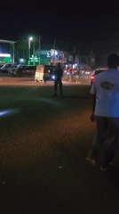 Night market scene captured with parked car incident