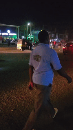 Night market scene captured with parked car incident