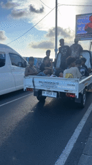 Branded pickup truck stops beside van in North Kuta