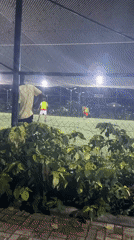 Nighttime soccer match played on enclosed field in Gura Top