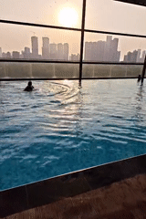 Rooftop pool swim captured against Mumbai sunset skyline