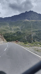 Road activity and a swollen river in Keylang's mountain terrain