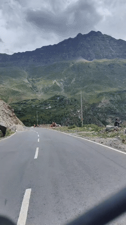 Road activity and a swollen river in Keylang's mountain terrain