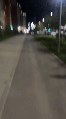Night stroll through a lit residential street in Astana