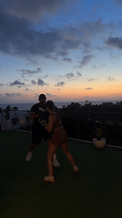 Woman trains boxing at sunset in North Kuta