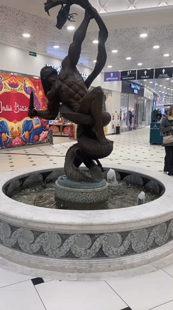 Morning shoppers document fountain statue at Yekaterinburg mall