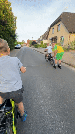 Family enjoys afternoon rollerblading and cycling in Fredenbeck, Germany