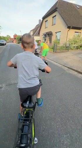 Family enjoys afternoon rollerblading and cycling in Fredenbeck, Germany