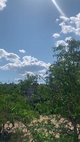 Summer skies over Kaniv's tree-lined streets, July 2026