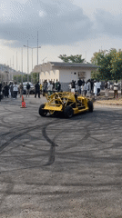 Custom yellow car performs burnouts for crowd in Abuja