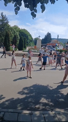 Children and adults gather for group activity in Bulgarian town square