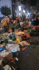 Semarang street market buzzing with vendors and fresh produce at night