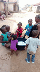Children play, goats graze in Akwanga Nigeria morning scene