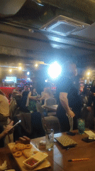 Evening social gathering documented at Red Bar with drinks and dining