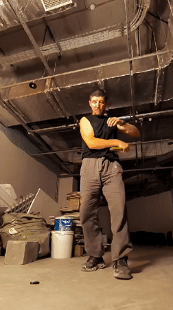 Nunchaku practice in a bare concrete utility room in Karaganda