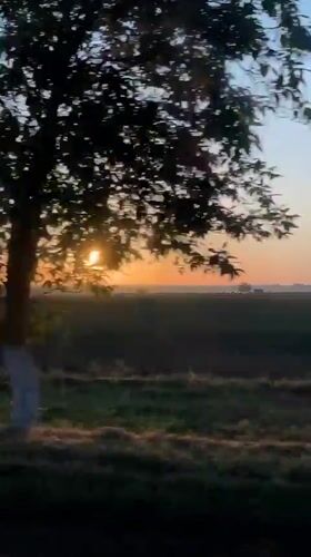Sunset captured over Moldovan farmland from moving vehicle